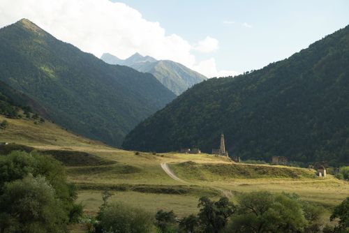 Free Mountainous landscape in Ingushetia, Russia featuring ancient tower ruins and lush greenery. Stock Photo