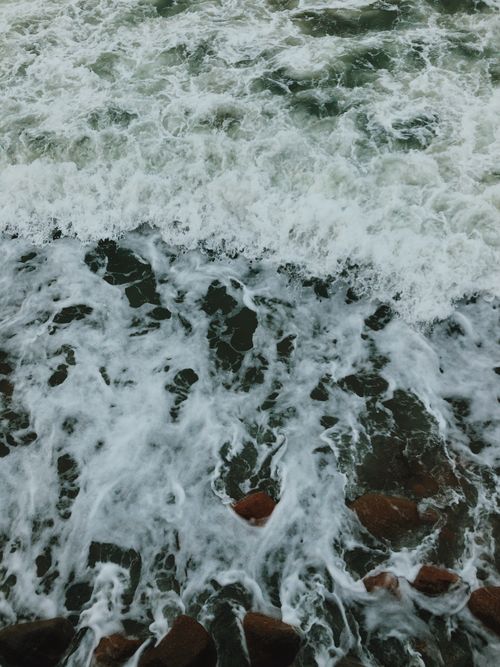Free Dynamic ocean waves crashing over rocky shore in Svetlogorsk, creating a frothy splash. Stock Photo