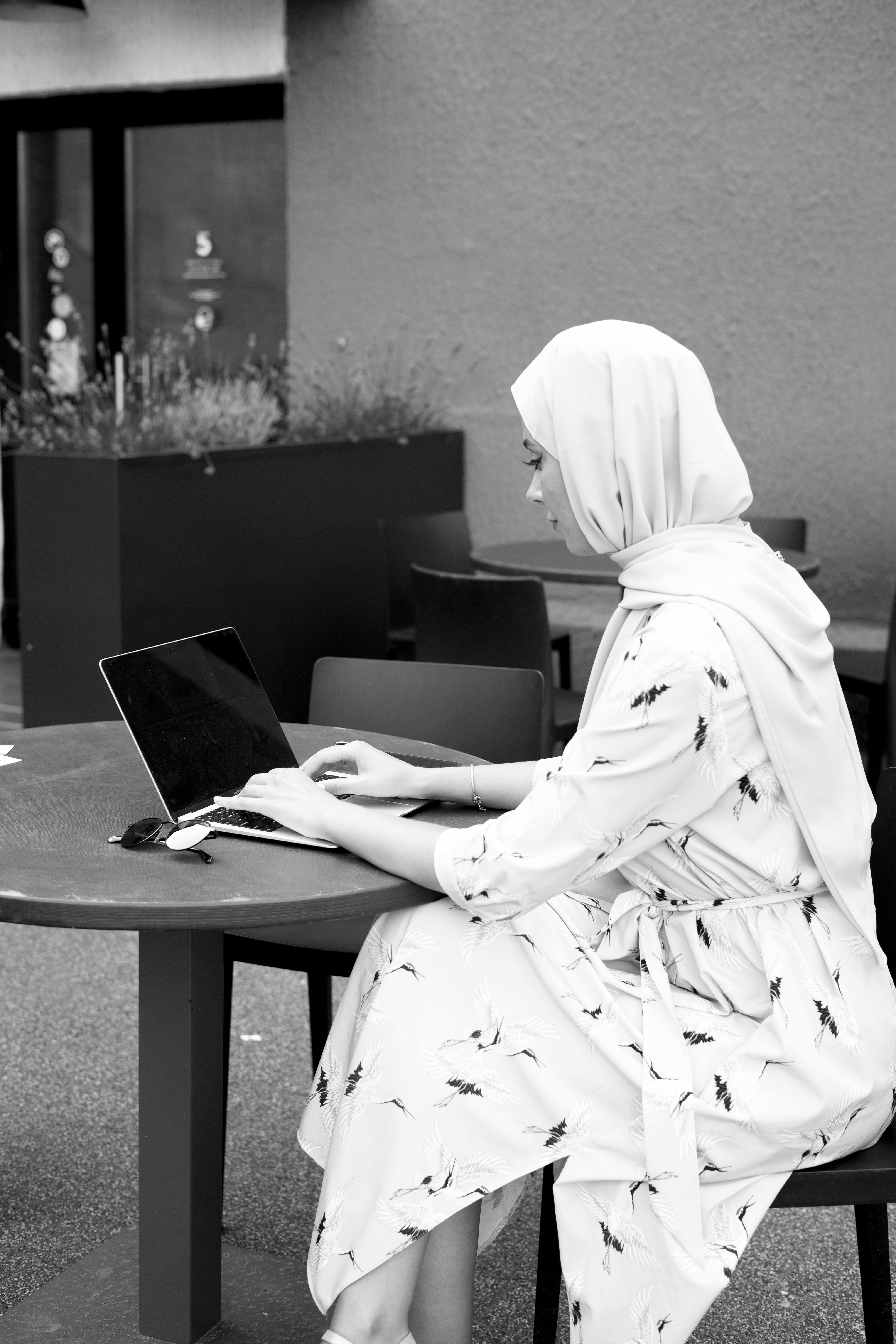 Grayscale Photo of a Woman Wearing Hijab while Using a Laptop · Free ...