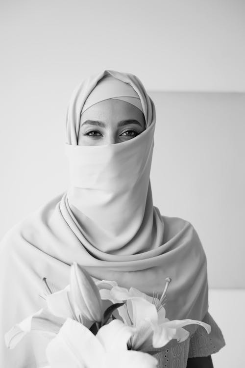 Grayscale Photo of a Woman Wearing Hijab