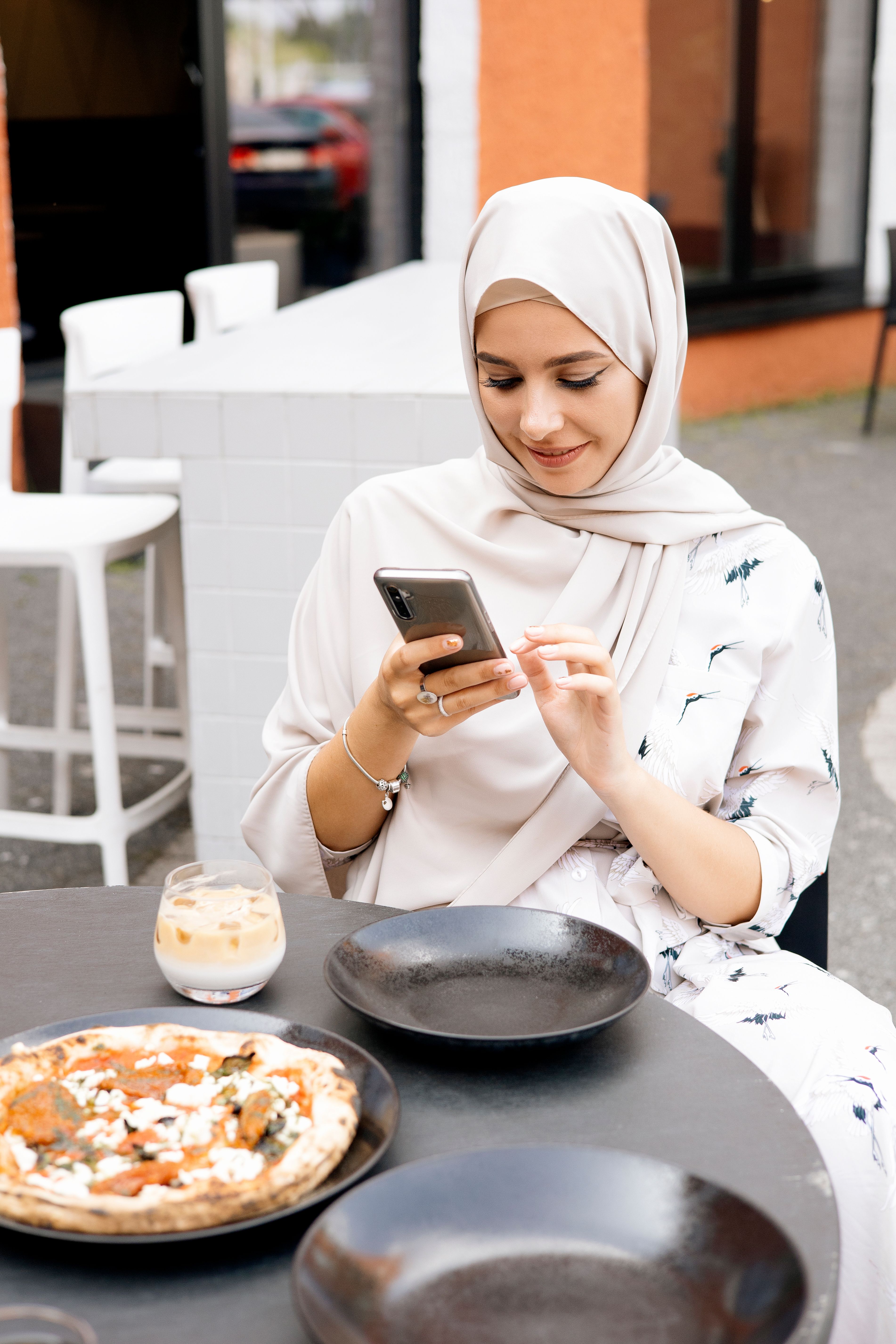 Woman Wearing Hijab Using a Cellphone · Free Stock Photo