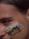 Woman with a Band Aid on Cheek