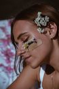 Woman with Bandage and Flowers on Face