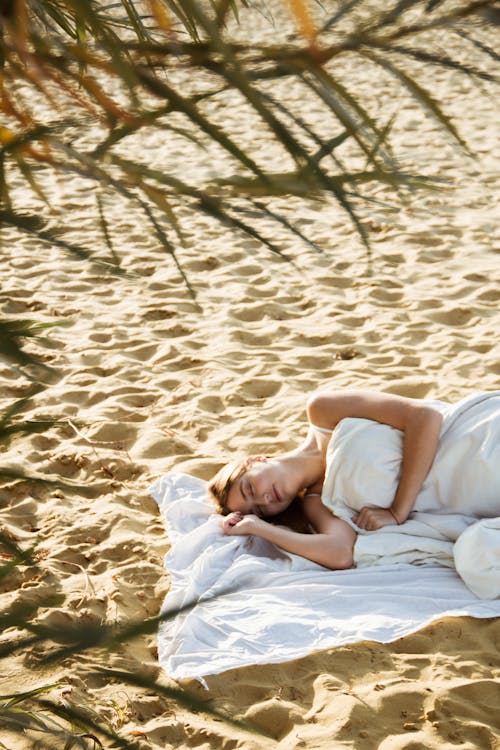 Free White Lying Down on a White Cloth in the Beach Stock Photo