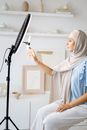 Woman in White Hijab Holding Microphone