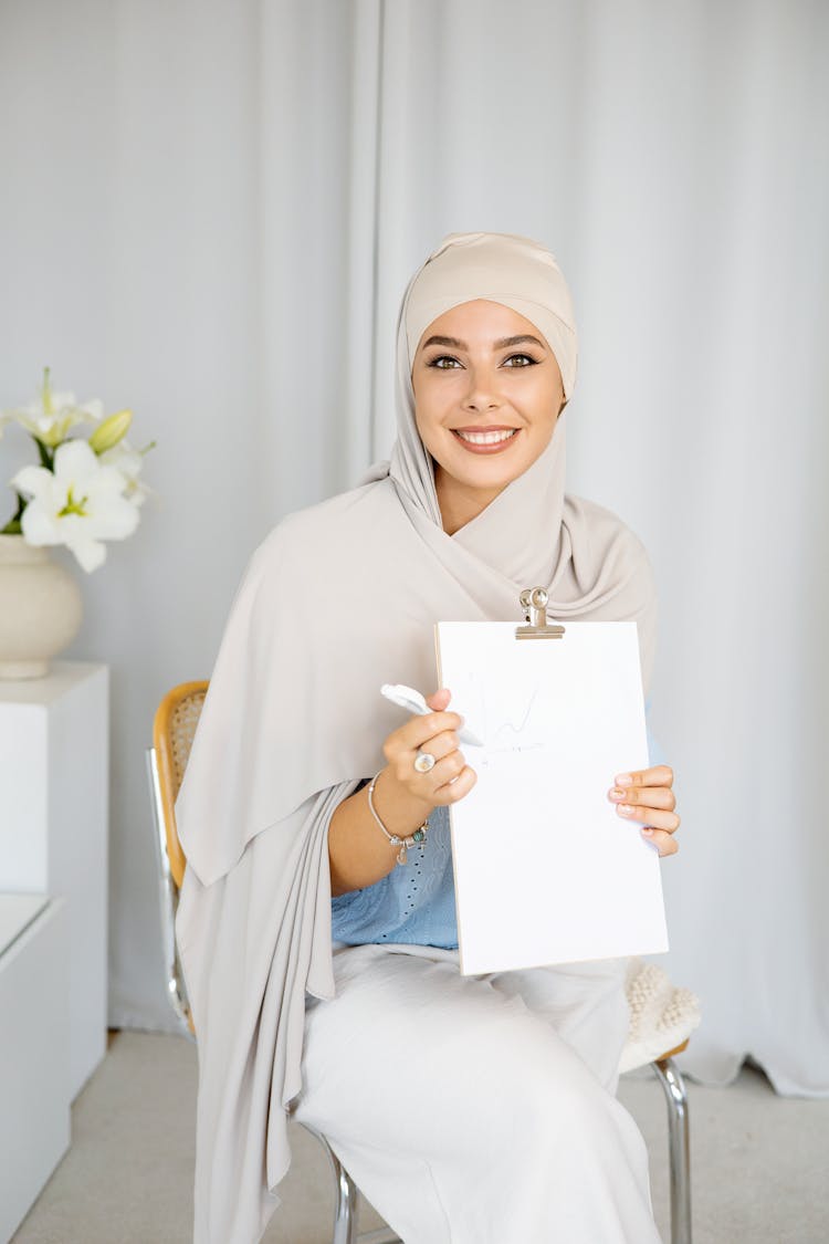 Beautiful Woman In A Hijab Holding A Clipboard