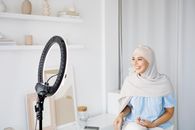 Woman in White Hijab Sitting on Chair