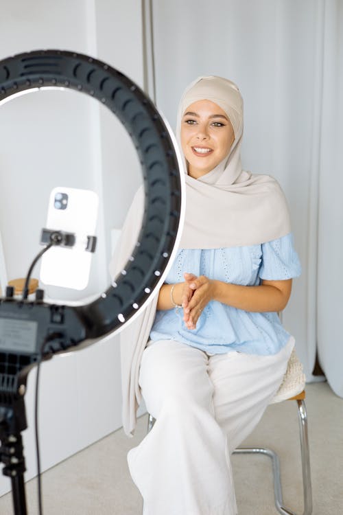 
A Woman Wearing a Hijab Recording Herself