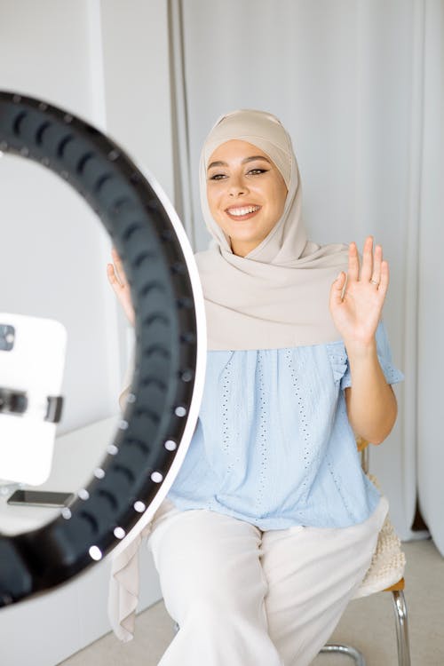 A Woman Wearing a Hijab Recording Herself
