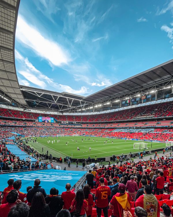 Crowd of fans watching a football match in a packed stadium