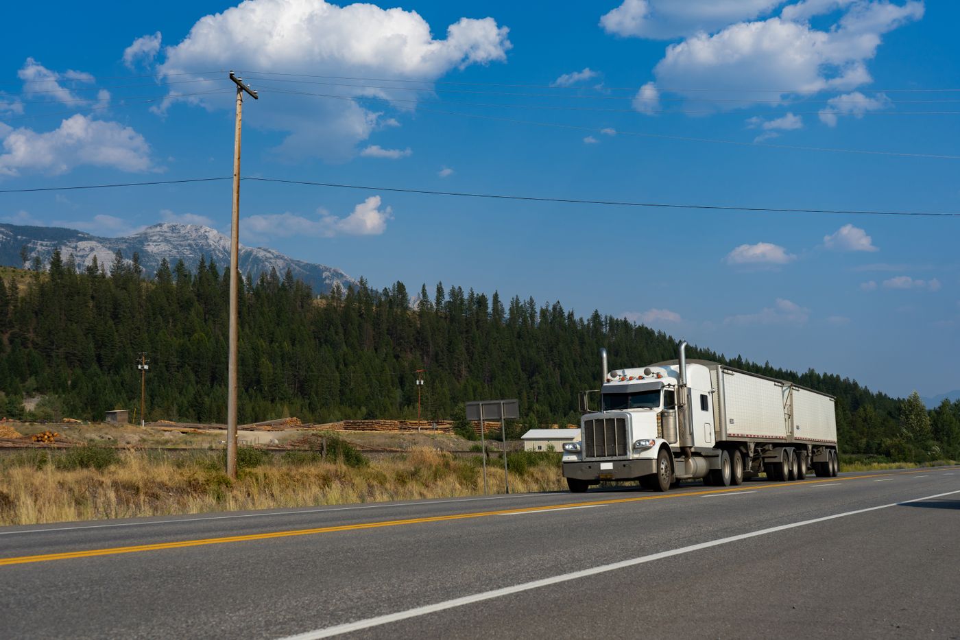 Unbranded white freight truck driving on the open road