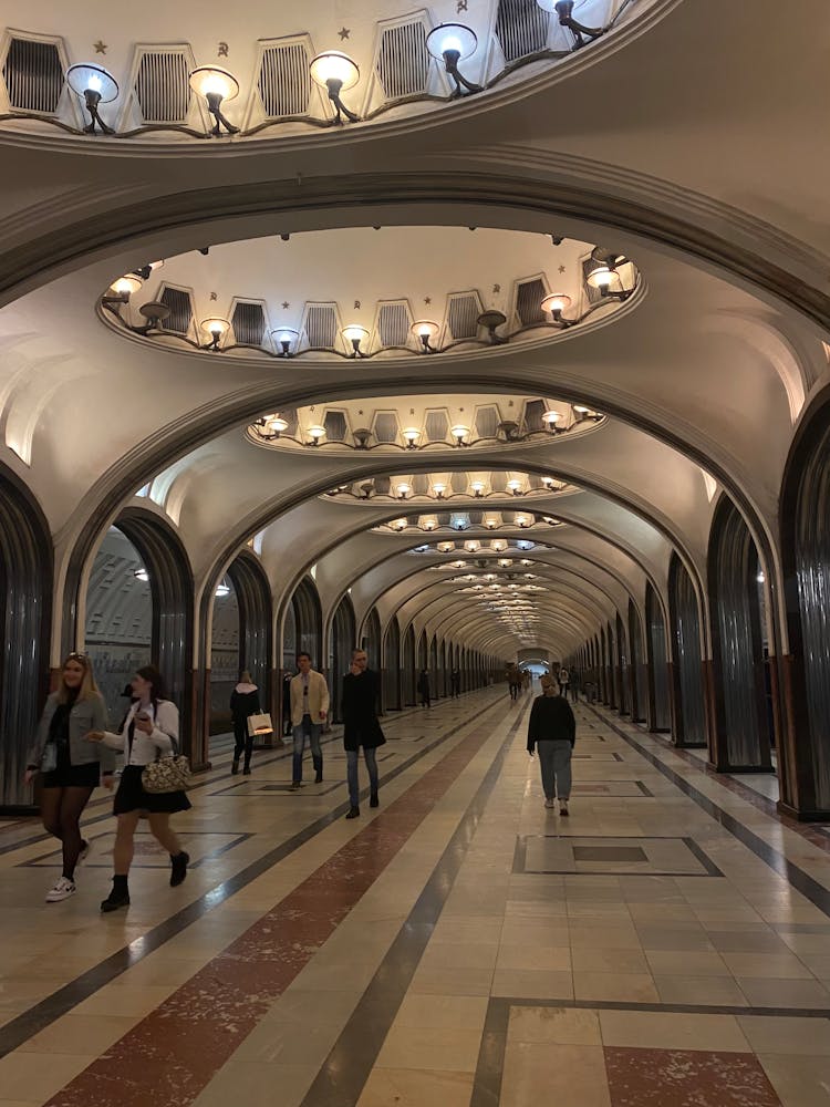 Busy People Walking On The Hallway Of A Building