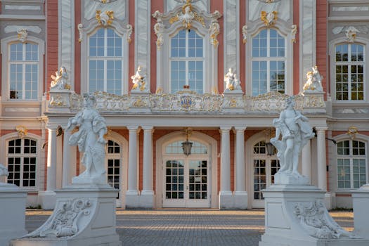 Elegant Baroque facade of a palace in Trier, Germany featuring ornate sculpture details.