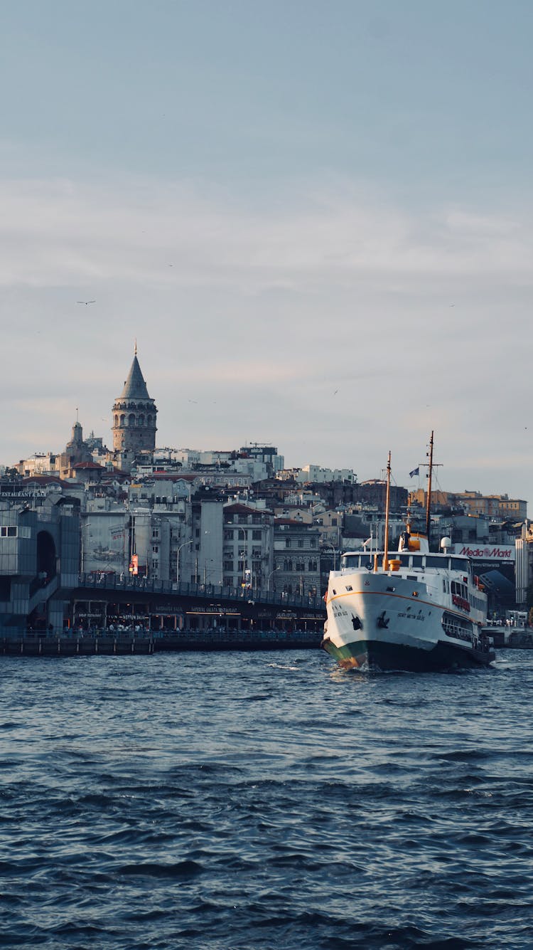 Ferryboat Cruising On The River Near The City