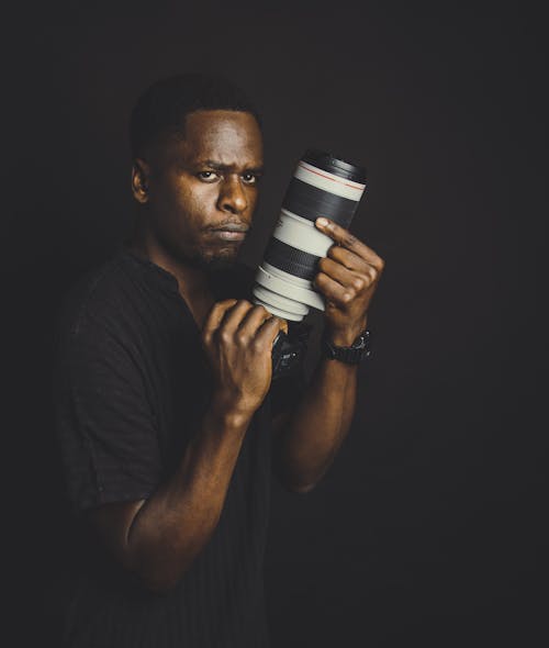 Man in Black Shirt Holding a Camera