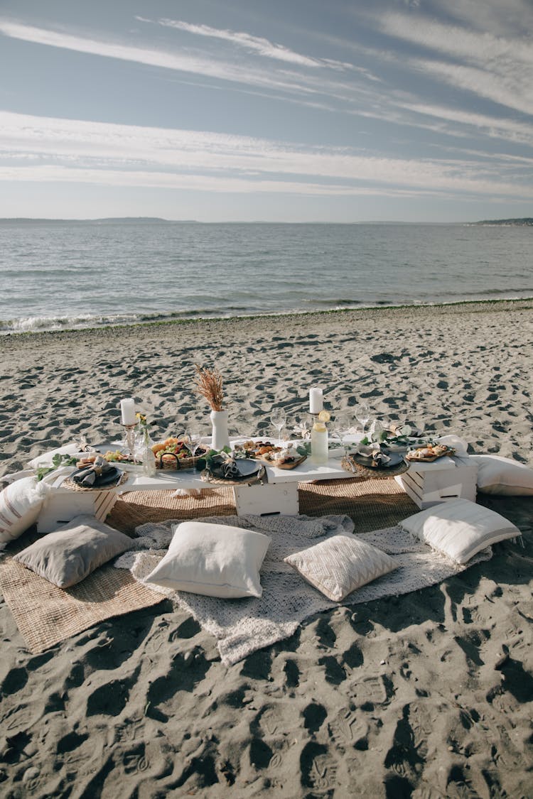 A Table With Food On The Beach