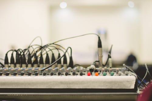 Black Electronic Device on White and Brown Table