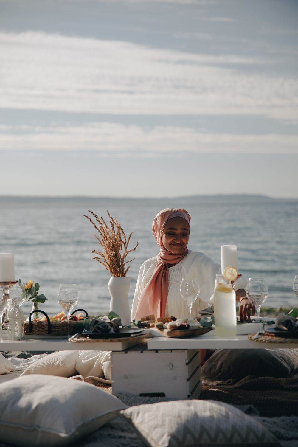 Woman in White Hijab Sitting by the Table with Food · Free Stock Photo