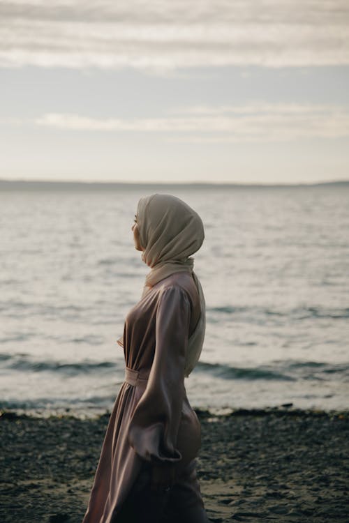 Free Woman in Hijab on the Beach Stock Photo