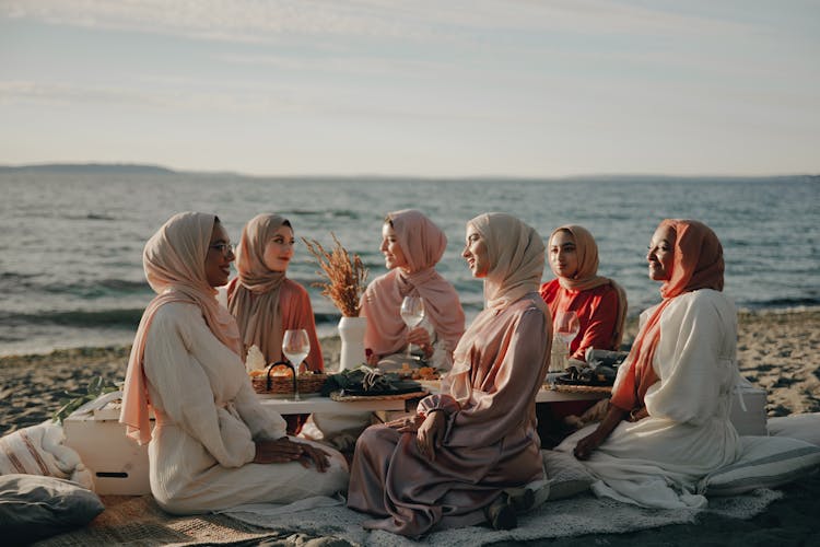 Friends Having A Picnic At The Beach