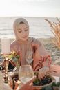Woman in Brown Hijab Sitting on Chair
