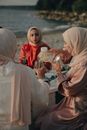 Woman in White Hijab Holding Clear Glass Cup