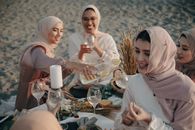 Woman in White Hijab Sitting Beside Woman in White Hijab