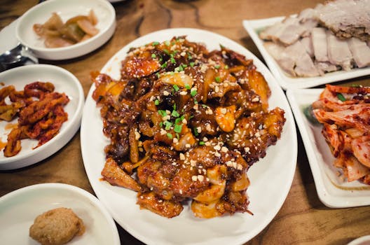 An appetizing spread of Korean dishes featuring spicy pork, kimchi, and side dishes.