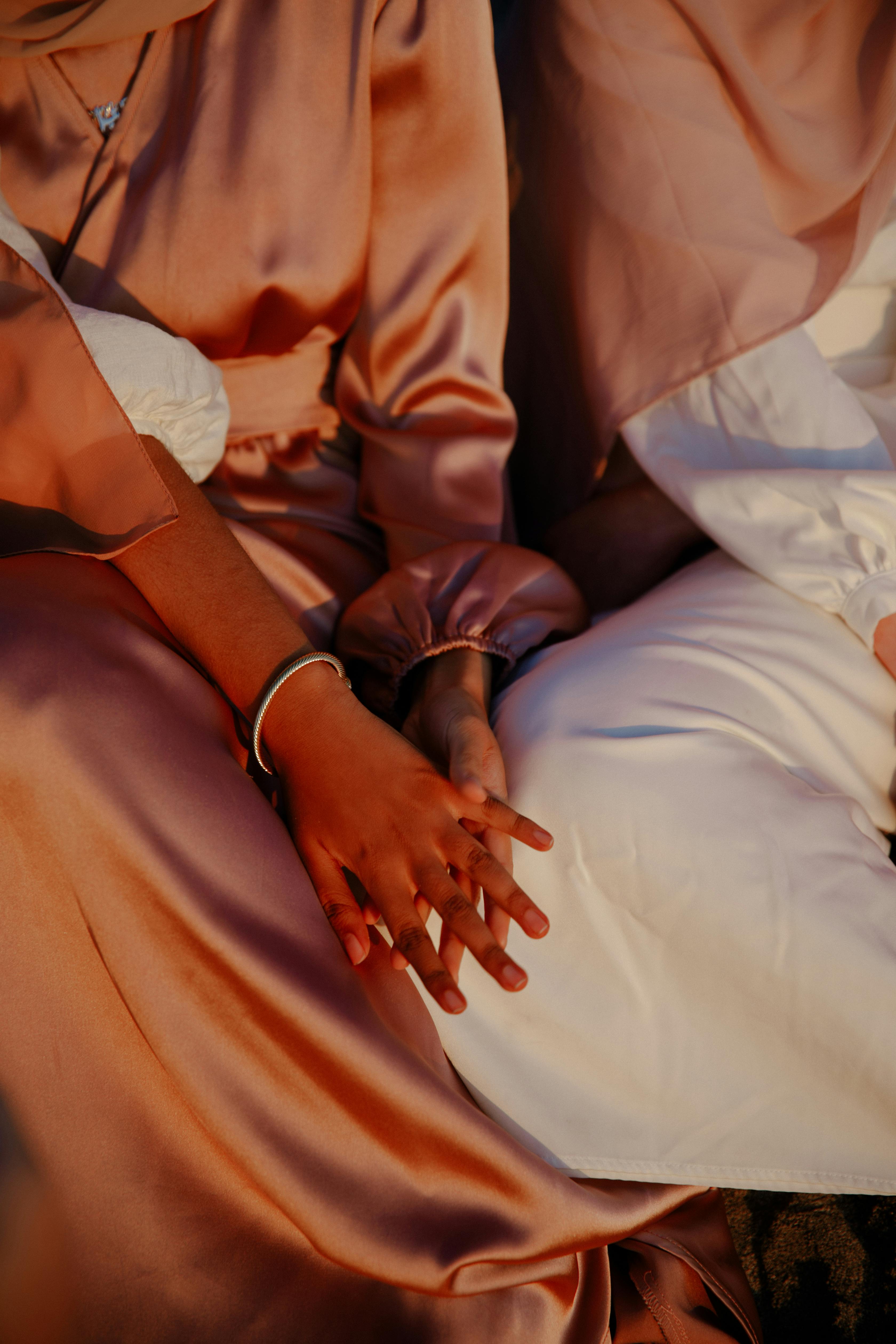 Close-up of elegant Muslim fashion featuring traditional clothing and warm tones.
