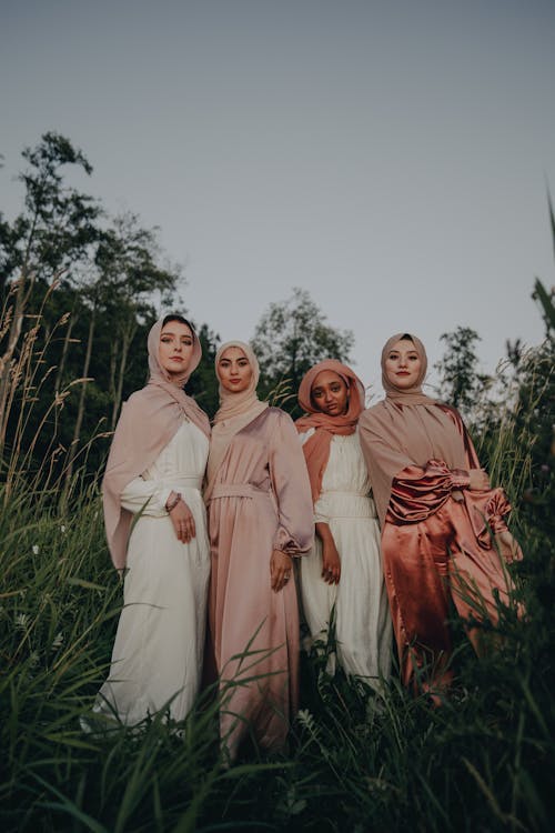 Group of Women Wearing Traditional Clothing, Posing in Bushes