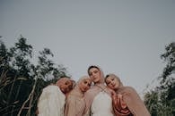 3 Women in White Dress Standing Near Green Tree