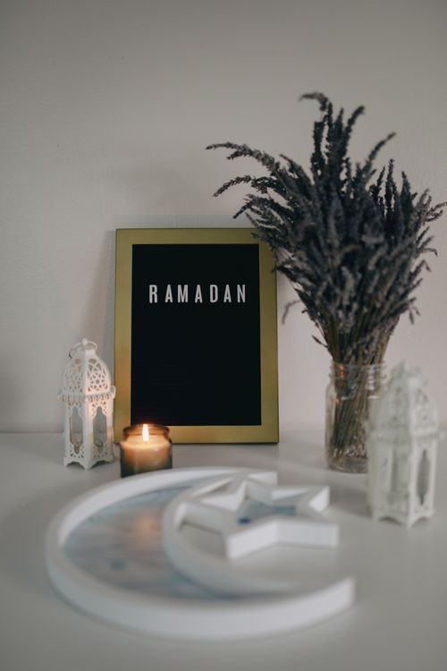 Free A sophisticated Ramadan display featuring a candle, dried flowers, and decor elements. Stock Photo