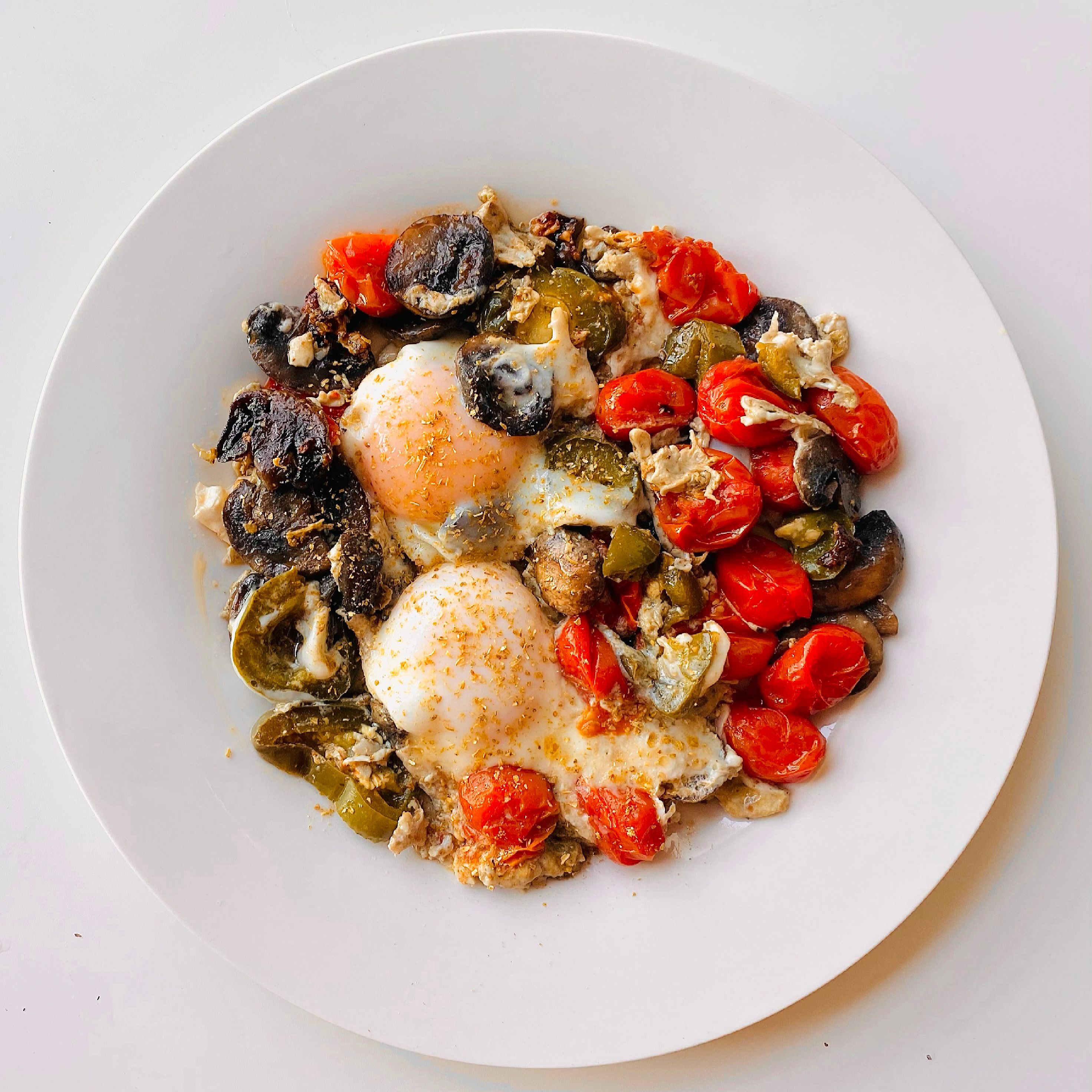 Poached eggs with blistered tomatoes and mushrooms on a plate — photo by I Own My Food Art on Pexels