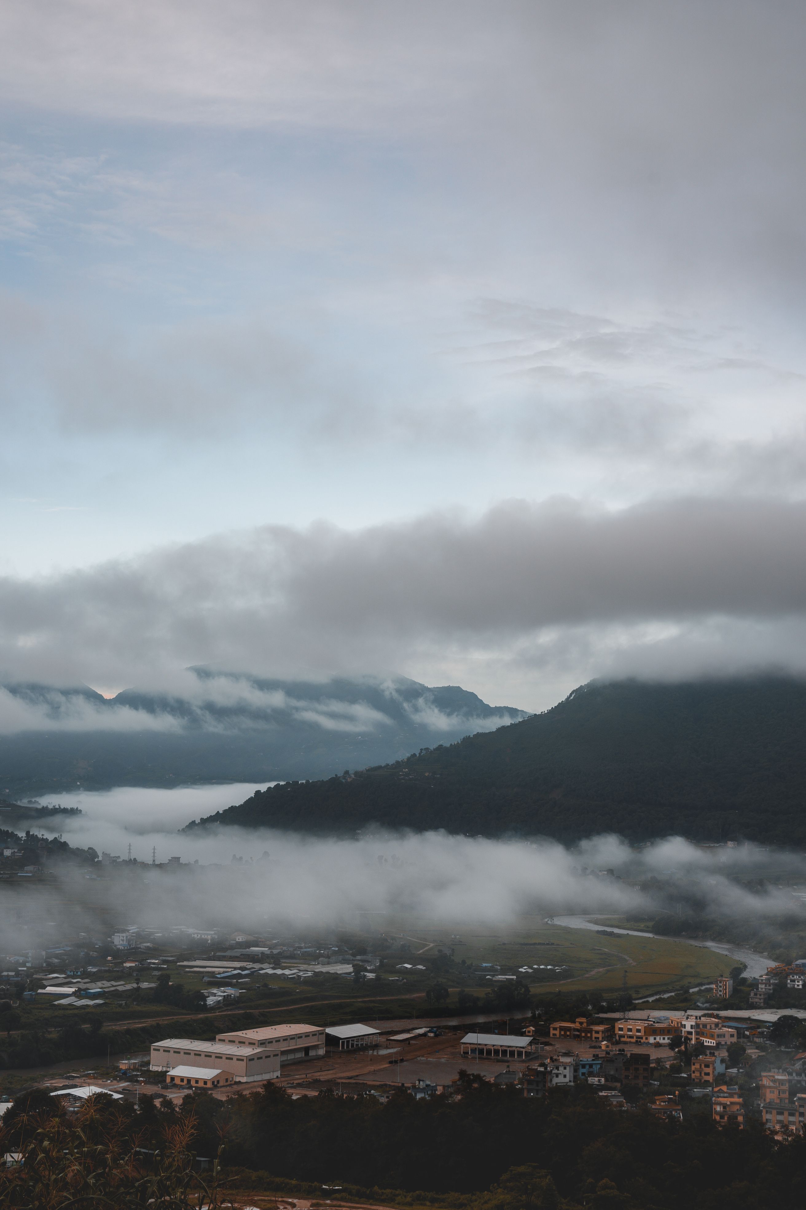 Aerial View of Buildings Near Mountain Under White Clouds · Free Stock ...