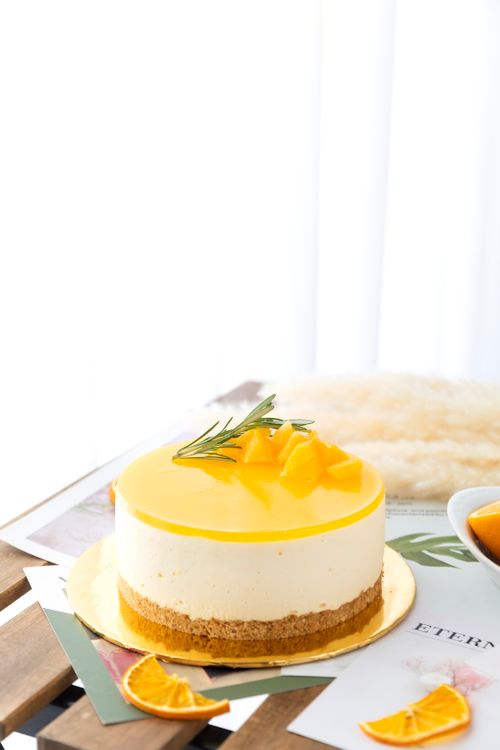 Free Scrumptious lemon cheesecake topped with fresh citrus and rosemary sprig. Stock Photo