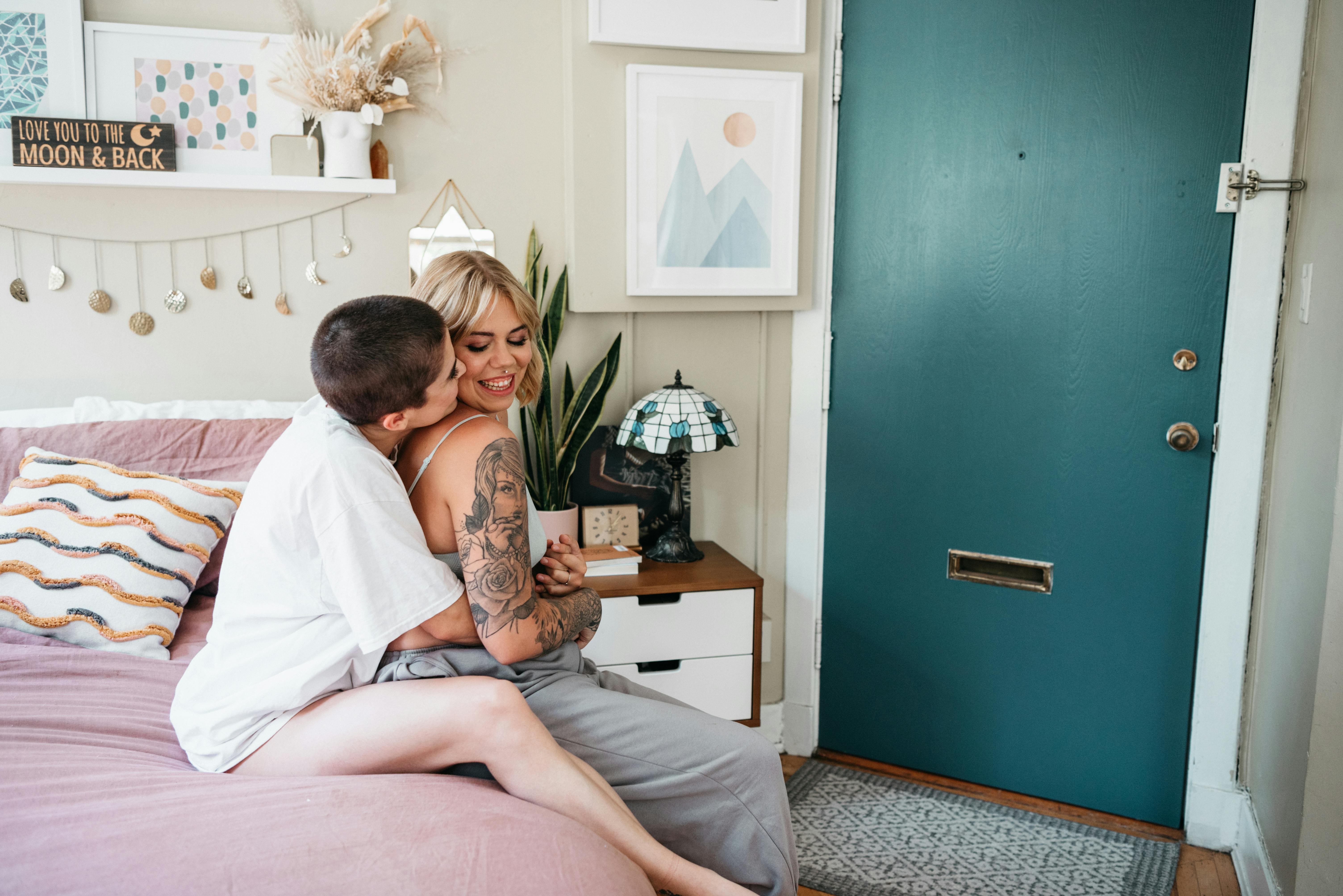 women sitting on bed