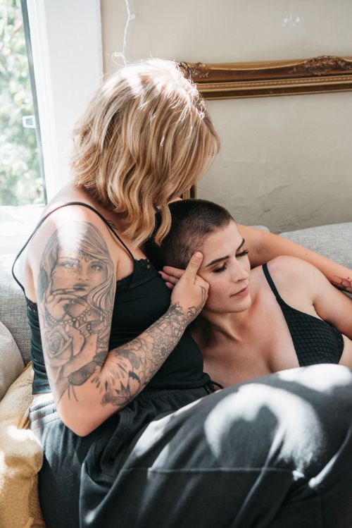 Free Two women share an intimate and tender moment on a sunny day indoors. Stock Photo