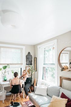 Two women enjoying a chat in a bright and cozy living room space.