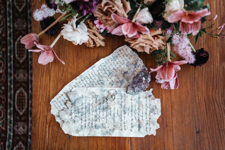 Beautiful Flowers, Wedding Rings And Papers With Speeches