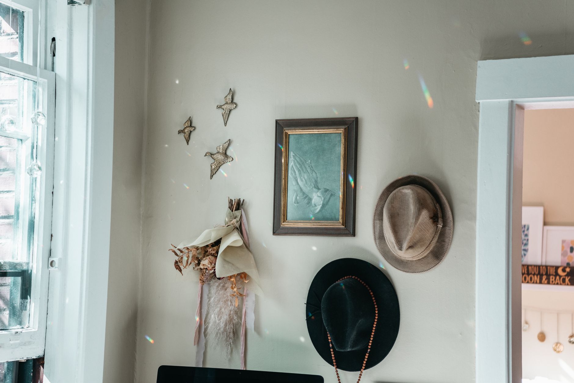 boho garage makeover with amazon finds Charming vintage interior featuring hats, wall art, and dried floral decor.