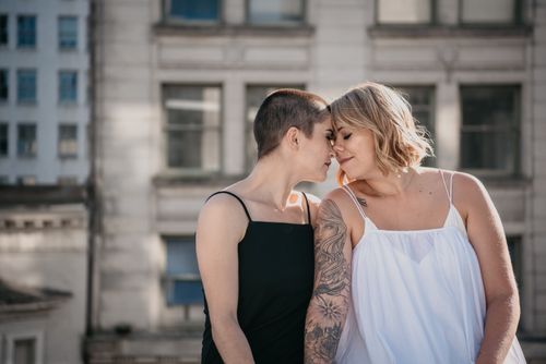 Free Two women share an intimate moment in an urban setting, symbolizing love and togetherness. Stock Photo