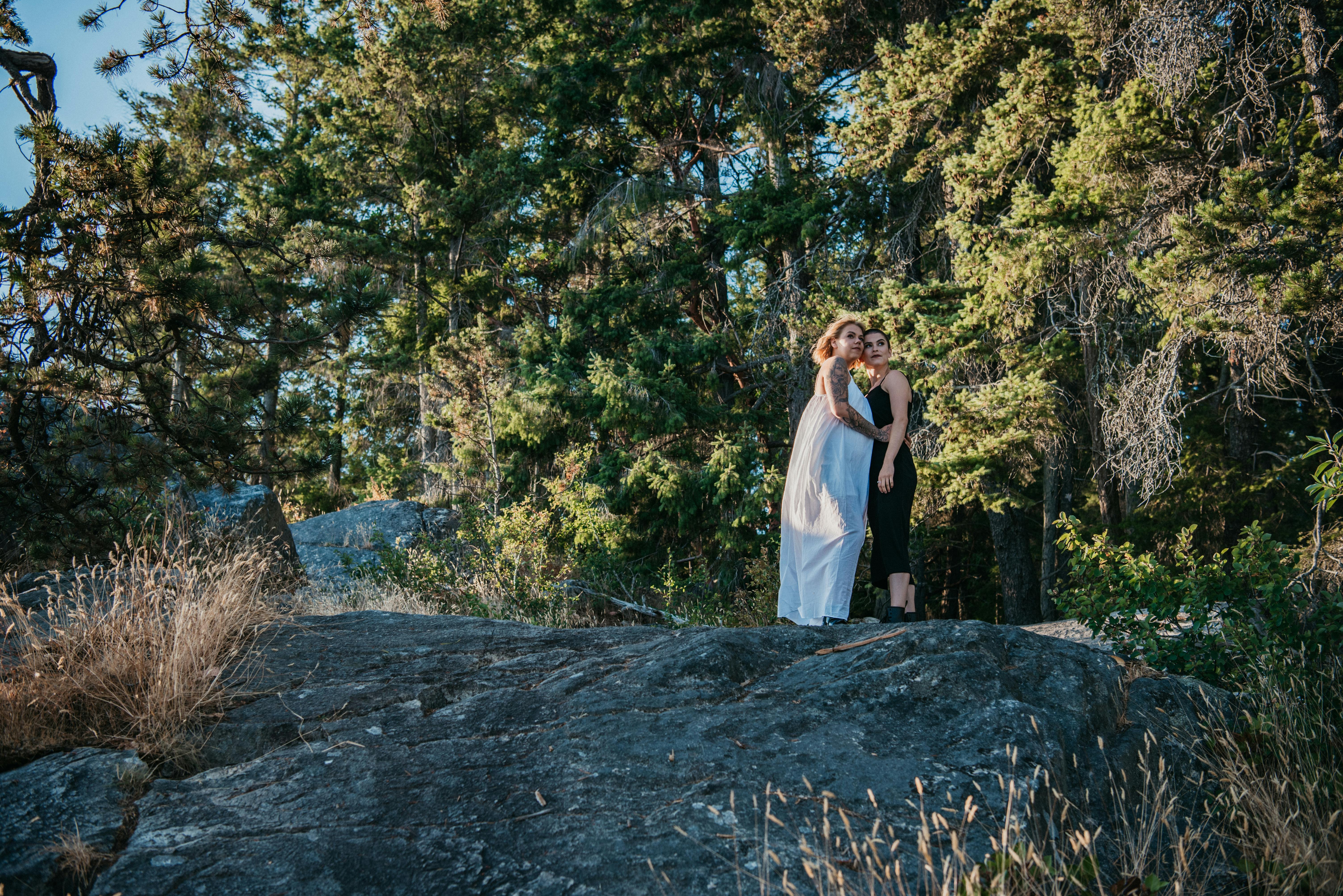 a couple standing on mountain rock