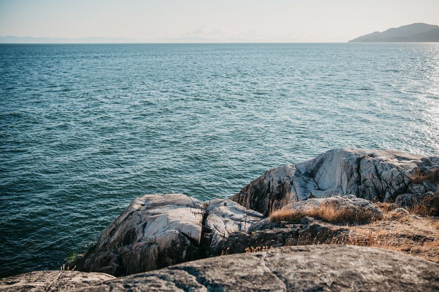 Breathtaking view of rocky coastal cliffs with the vast ocean stretching to the horizon.