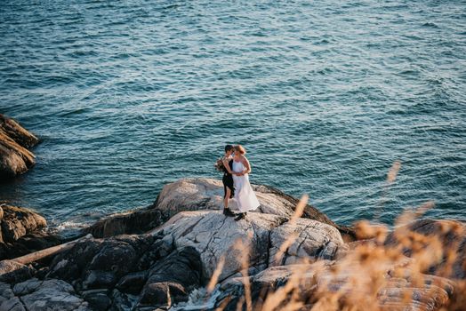 A Couple Standing on Sea Rock