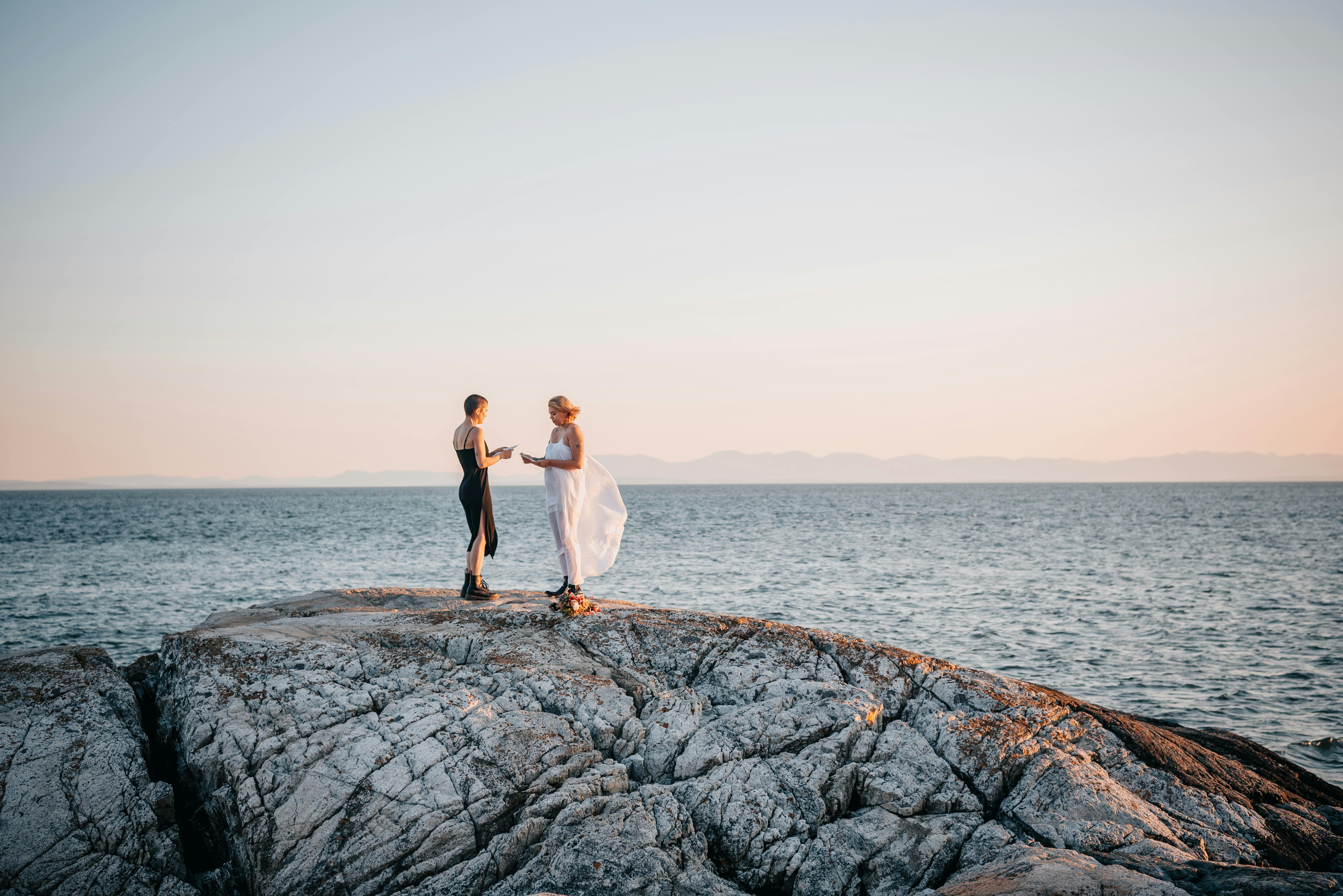 two girls standing on the big rock