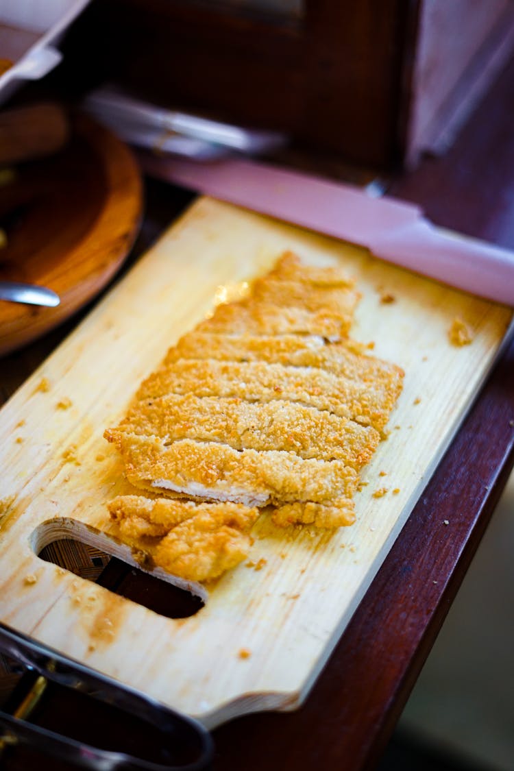 Sliced Breaded Pork On A Chopping Board