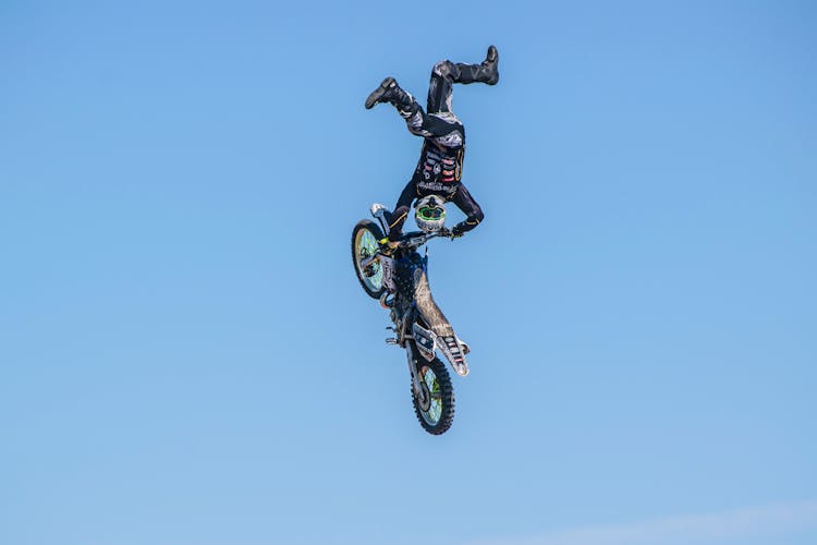 Man Riding Motocross Dirt Bike Doing Stunts