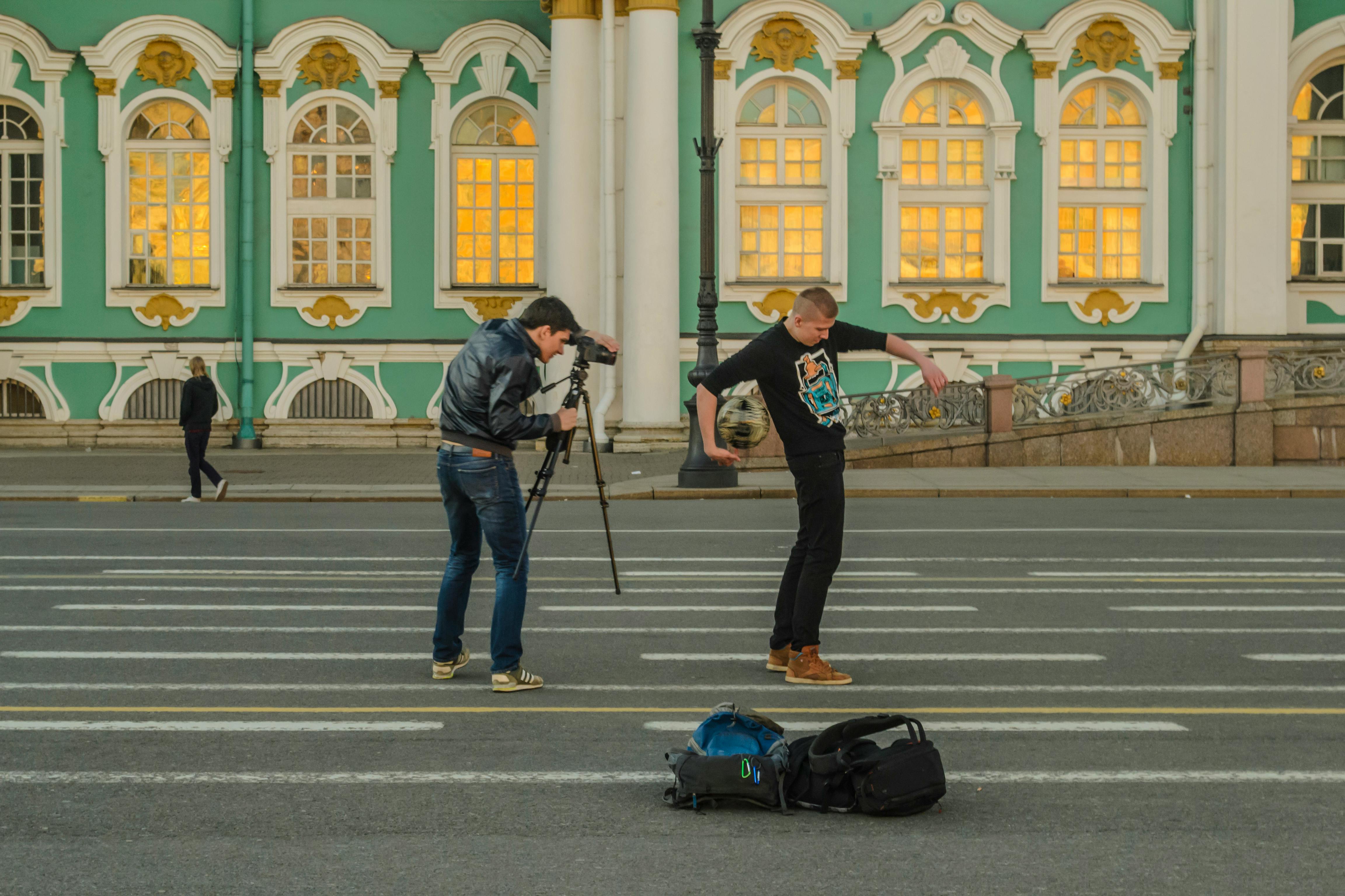 Free Man in Black Jacket Taking a Photo of Man in Black Crew Neck T Shirt Stock Photo