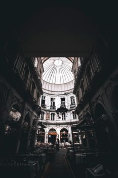 Capture of an elegant dining area beneath a dramatic dome ceiling. Low angle shot indoors.