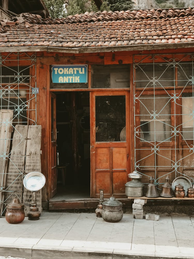 Brown Wooden Antique Store With Antique Items Displayed Outside